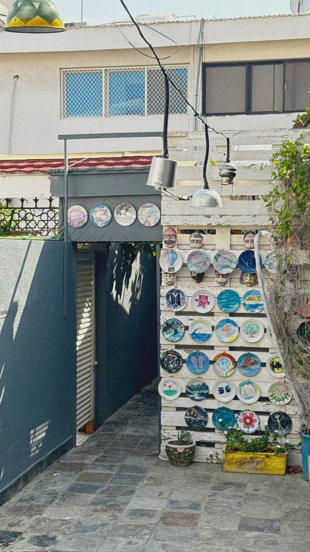 abu-dhabi-art-house-cafe_colorful-painted-plates-on-the-wall_fwrto_28-04-2026
